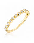 18k yellow gold band with bezel-set round diamonds by Henri Daussi.