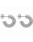 A pair of silver crescent-shaped hoop earrings with a textured, ribbed exterior and butterfly backings, shown on a plain white background.
