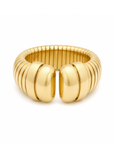 A wide, chunky gold ring with a ribbed segmented band and two large rounded front sections, photographed on a clean white background.