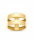 A pair of polished yellow gold rings stacked together on a clean white background.