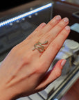 yellow gold ring in the design of a snake on a hand.