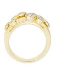 A yellow gold ring featuring a curved top adorned with multiple round-cut clear gemstones, shown against a plain white background.