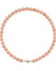 This beaded necklace features a strand of orange moonstone beads that measure 8mm in diameter each. The 16 inch strand is finished with a magnetic ball clasp.