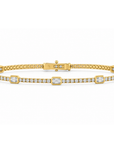 Diamond line bracelet with emerald and round diamonds.