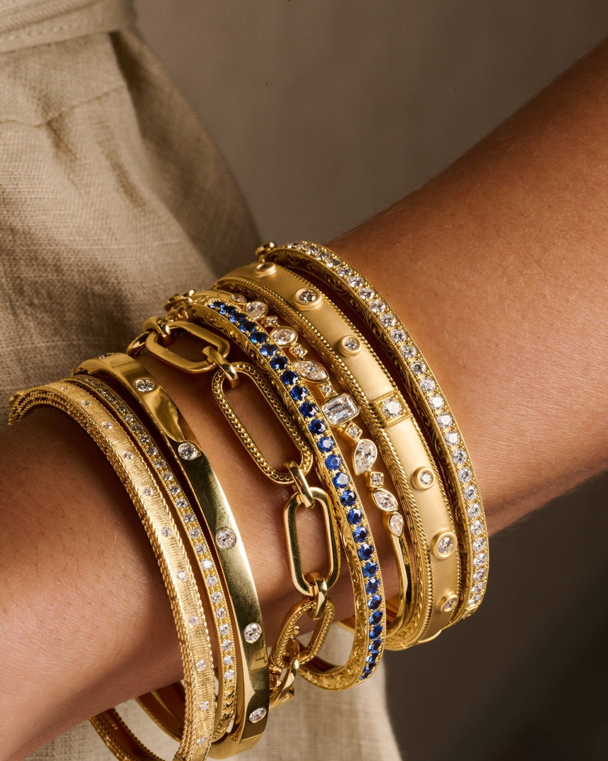 stacked gold bangles on wrist