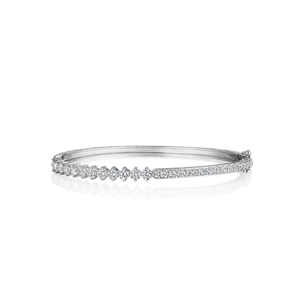 This 18k white gold bangle from Penny Preville features round diamonds that total 2.34ctw. Half of the diamonds are prong set, with the other half being channel set. The bangle measures 4mm wide.