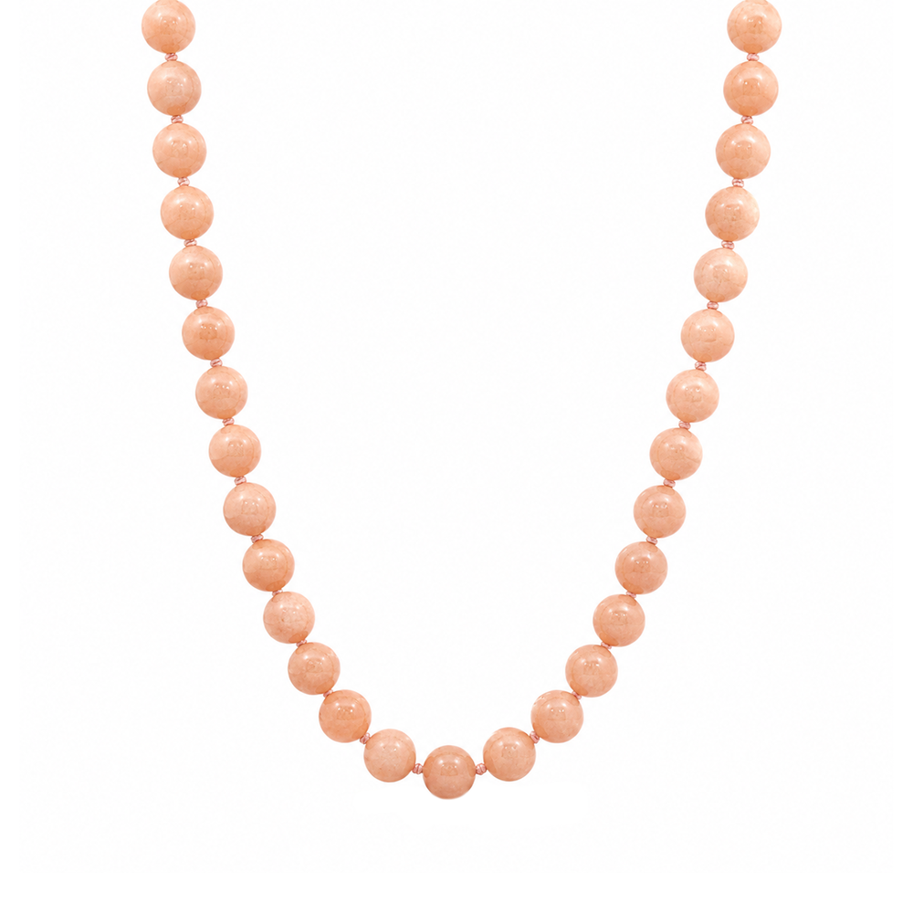 This beaded necklace features a strand of orange moonstone beads that measure 8mm in diameter each. The 16 inch strand is finished with a magnetic ball clasp.