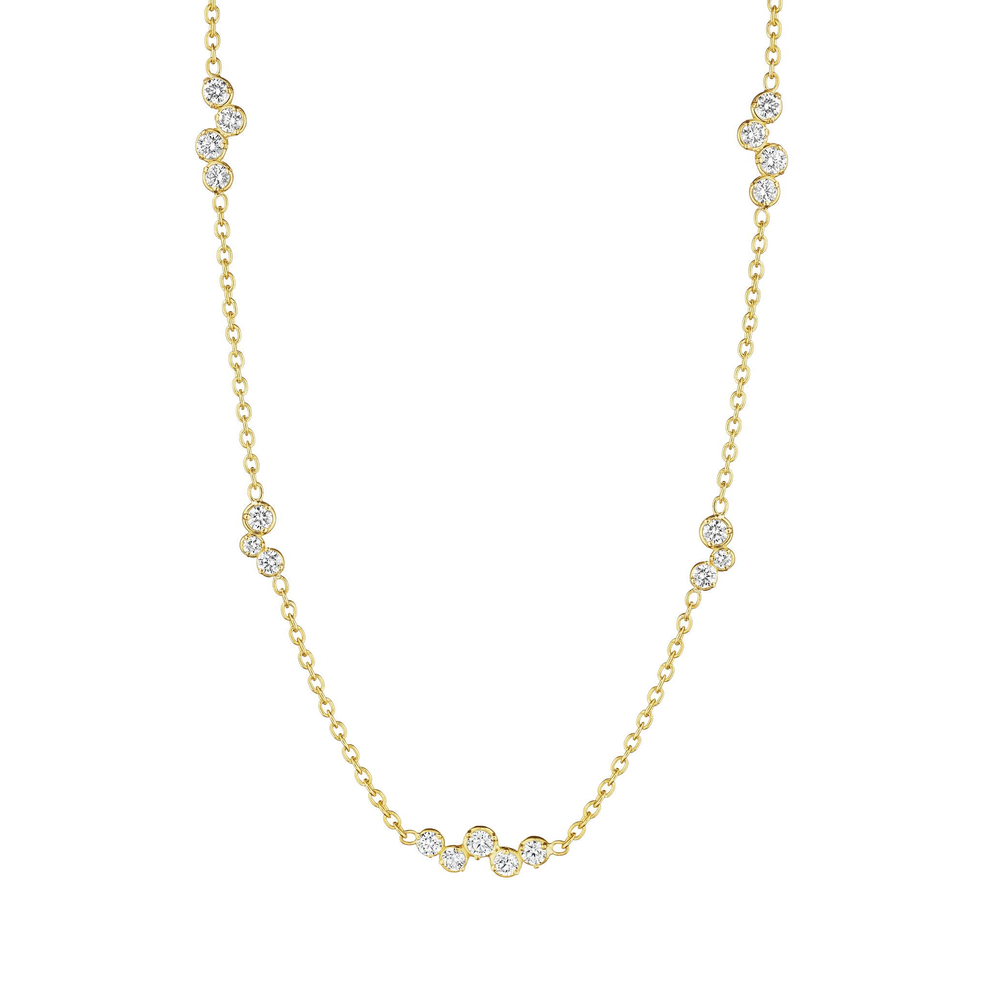 This 18K yellow gold necklace from Penny Preville features bezel-set round diamonds totaling 0.76ctw, arranged in clusters of three and five and spaced along an 18 inch chain.