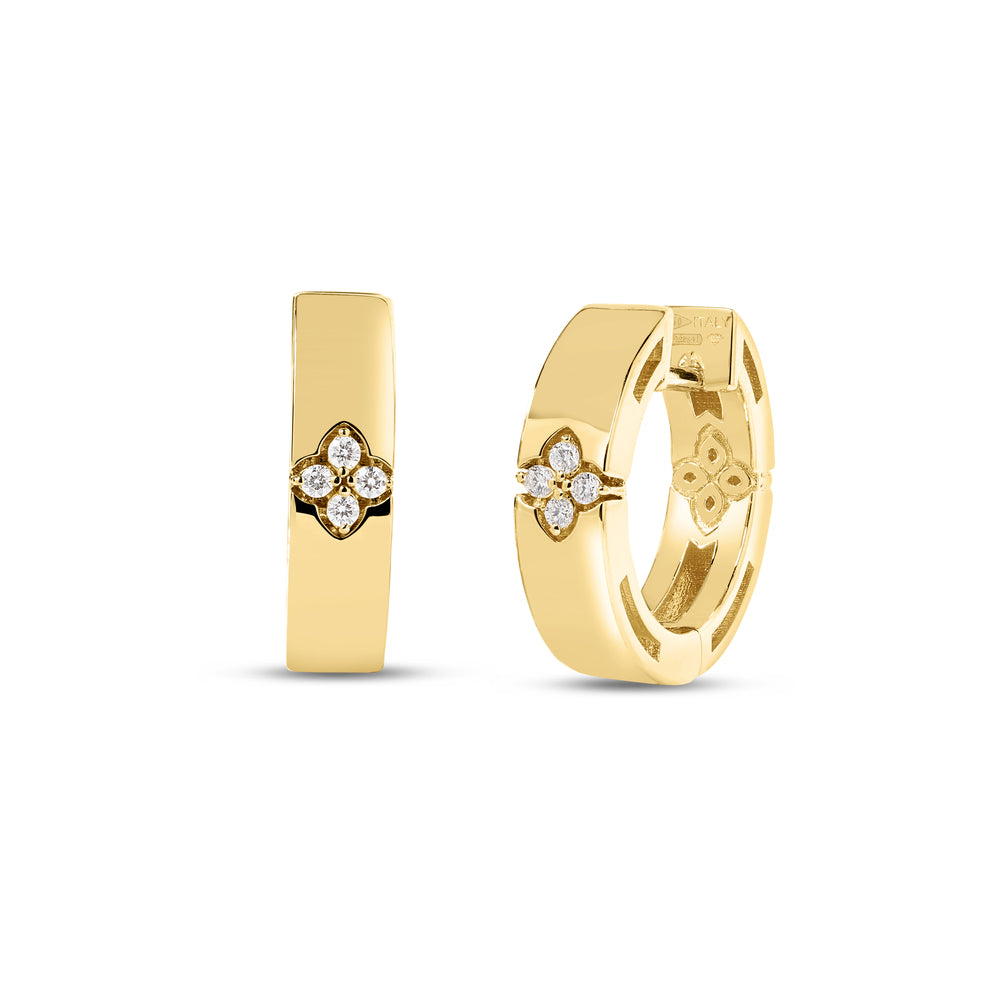 These 18k yellow gold hoop earrings from the Love in Verona collection by Roberto Coin feature a narrow hoop design with four round diamonds set in the center of the hoop in the shape of the signature Roberto Coin flower. The diamonds measure 0.03ctw and the hoops measure 15mm x 3.5mm.