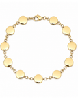 Polished yellow gold bracelet featuring flat round discs connected by short chain links with a lobster clasp.
