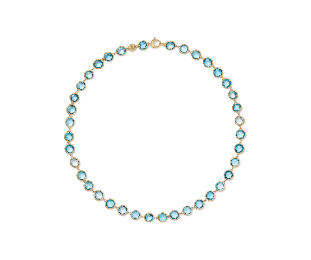 18K yellow gold station necklace featuring bezel-set, rose-cut round blue topaz gemstones arranged in a continuous line with a lobster clasp. Displayed on a white background.