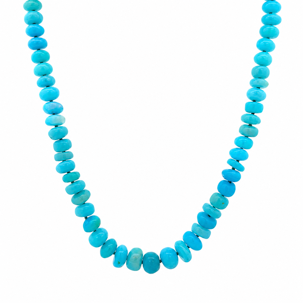 This beaded necklace showcases graduated blue opal gemstones, with the largest stones centered. The strand is finished with a sterling silver magnetic clasp and measures 16 inches. Wear this necklace on its own or as the statement piece for a layered necklace stack.