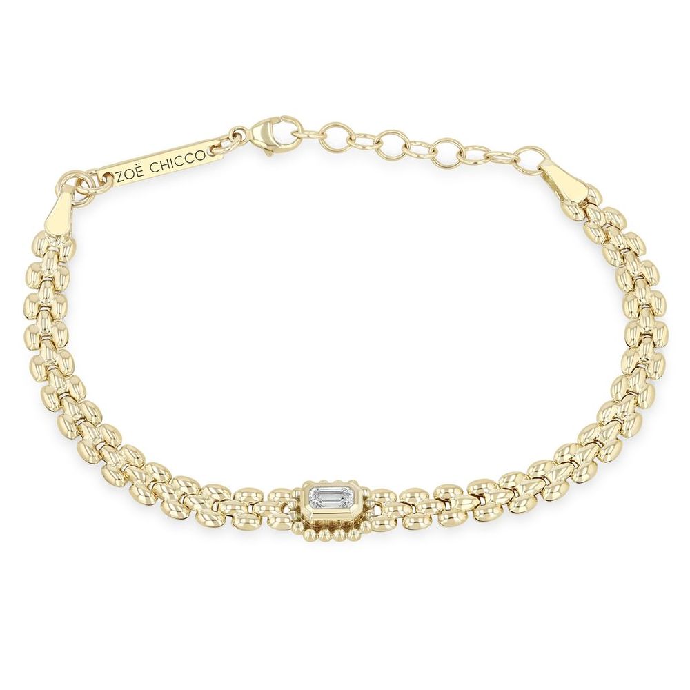 This 14k yellow gold bracelet features a panther chain with a center bezel set emerald cut diamond that totals 0.36ctw with a beaded halo. This bracelet measures 6 inches in length with an adjustable chain.