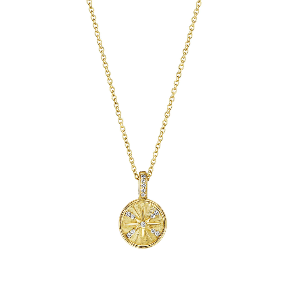 This 18k yellow gold necklace from the Petite Penny collection by Penny Preville features a round pendant with a starburst design that measures 10mm in length. The pendant features round diamonds that total 0.057ctw and suspends from a gold chain.