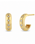 14k yellow gold huggie earrings from Zoe Chicco features five bead set diamonds that total 0.10ctw. Shown on a white background.
