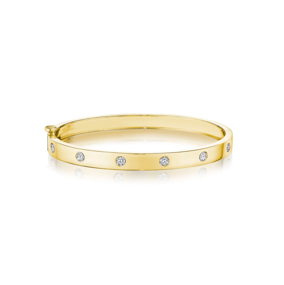 This 18k yellow gold bangle from the Moderne Deco collection by Penny Preville features round diamonds flush set in the bangle that total 0.60ctw. The bangle measures 5.8mm in thickness.