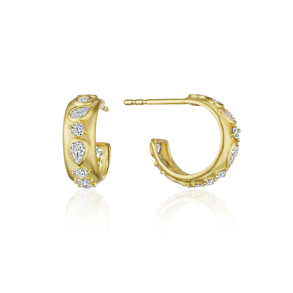 These 18k yellow gold huggie earrings from Penny Preville feature round and pear shaped diamonds that total 0.93ctw. The earrings measure 14mm in diameter.