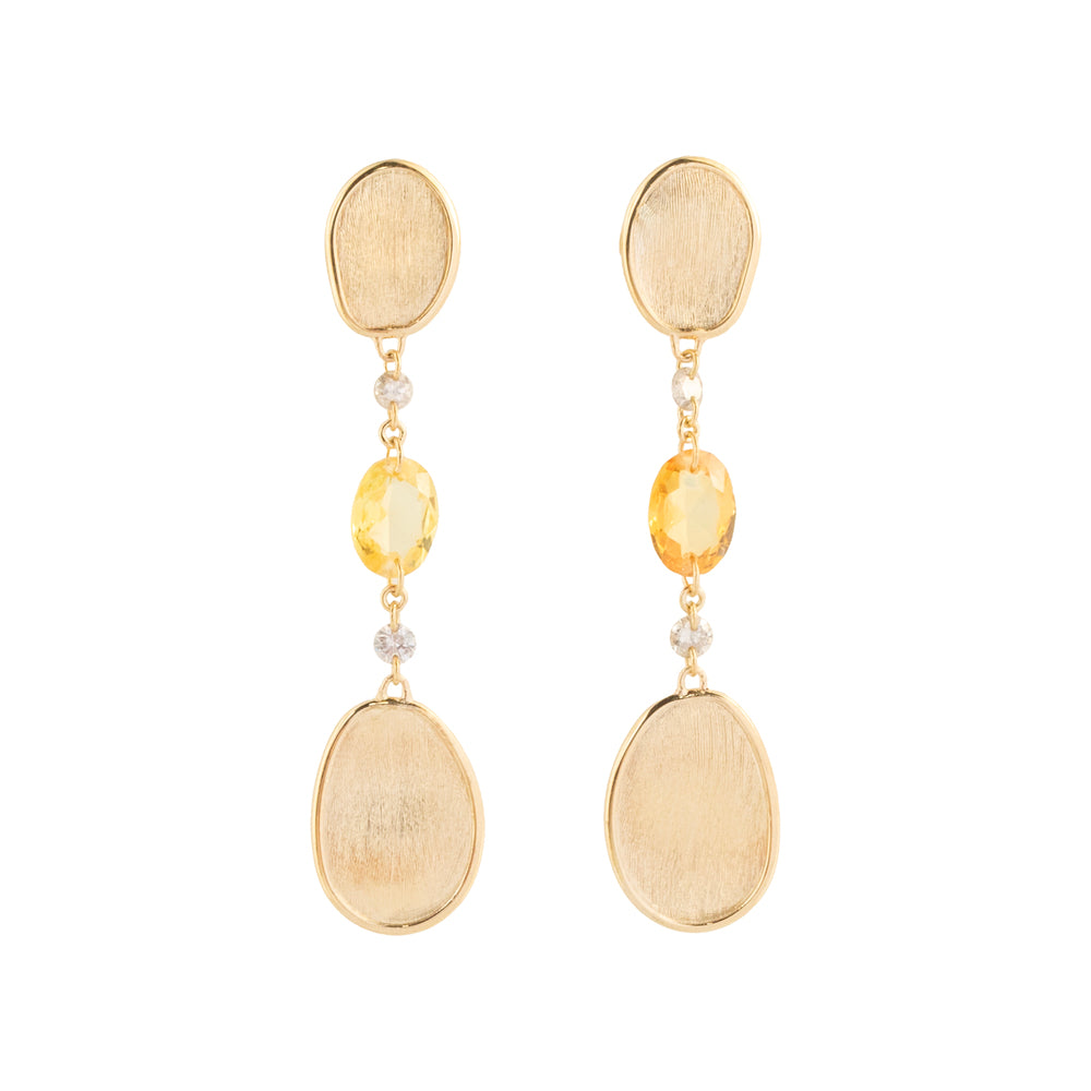 These 18k yellow gold drop earrings from the exclusive Unico collection by Marco Bicego feature a brushed finish oval gold petal. An oval orange sapphire is suspended between two round brown diamonds that total 0.26ctw, each connected by delicate chain links.