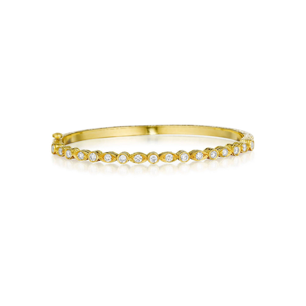 This 18k yellow gold bangle from Penny Preville features alternating bezel set marquise and round diamonds that total 1.02ctw.