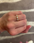 This 18k yellow gold band features five bezel set pear diamonds that total 1.01ctw. This ring measures as a size 6.5.