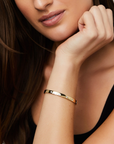This 18k yellow gold bangle from the Moderne Deco collection by Penny Preville features round diamonds flush set in the bangle that total 0.60ctw. The bangle measures 5.8mm in thickness.