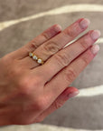 This 18k yellow gold band features five bezel set pear diamonds that total 1.01ctw. This ring measures as a size 6.5.