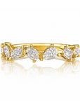 This 18k yellow gold band features 7 mixed shaped diamonds set scattered around the band that total 0.90ctw. This ring measures as a size 6.50.
