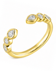 18k yellow gold open band with bezel-set round and pear diamonds.