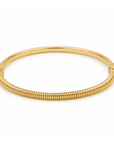 A polished yellow gold hinged bangle bracelet with a textured, ribbed outer band and smooth inner band, shown on a plain white background.