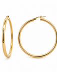 A pair of polished gold hoop earrings, one shown from a side profile and the other from a front-three-quarter angle, on a clean white background.