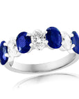 18k white gold band featuring alternating oval diamonds and blue sapphires.