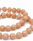 This beaded necklace features a strand of orange moonstone beads that measure 8mm in diameter each. The 16 inch strand is finished with a magnetic ball clasp.