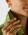 18K yellow gold hoop earrings featuring bezel-set, rose-cut round yellow quartz gemstones arranged in a continuous line. Displayed on a model.