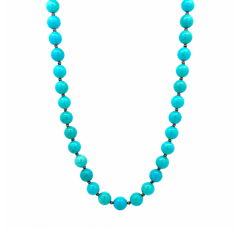 This beaded necklace features a strand of turquoise stone beads that measure 8mm in diameter each. The 16 inch strand is finished with a sterling silver magnetic ball clasp.