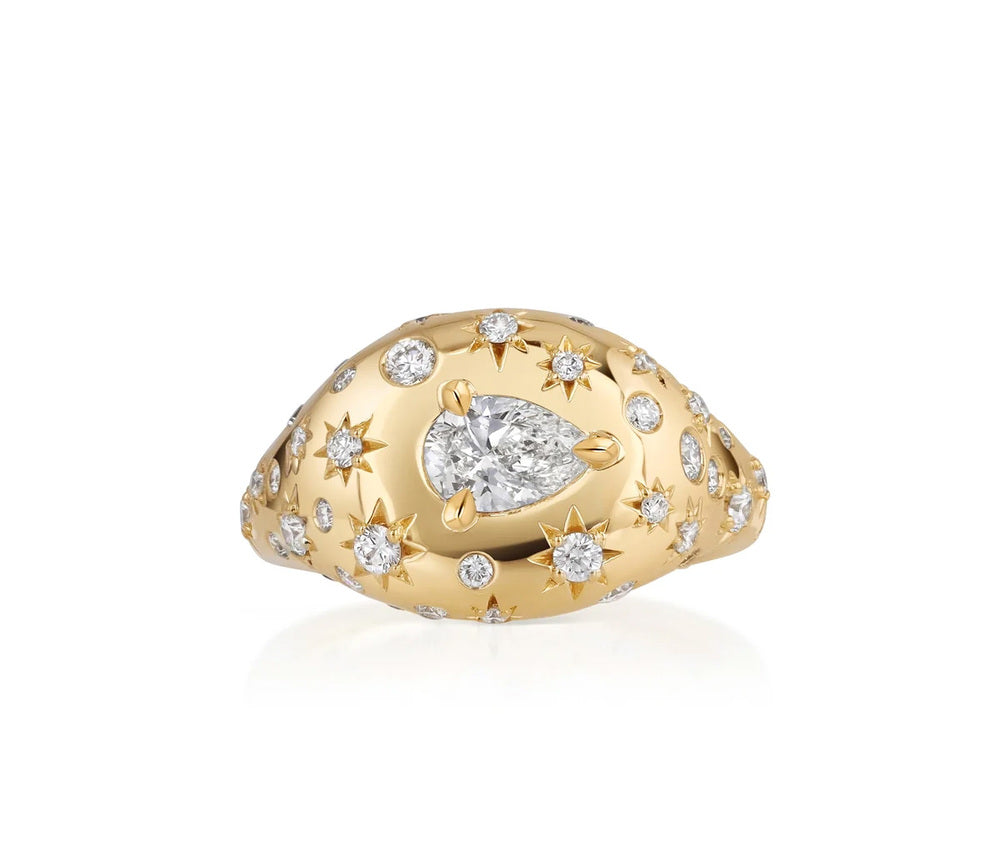 This 18k yellow gold pinky signet ring from the Supernova collection by Phillips House features a center pear diamond that totals 0.30ctw with round diamonds that total 0.37ctw scattered throughout the ring, some diamonds star-set.