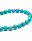 This beaded necklace features a strand of turquoise stone beads that measure 8mm in diameter each. The 16 inch strand is finished with a sterling silver magnetic ball clasp.