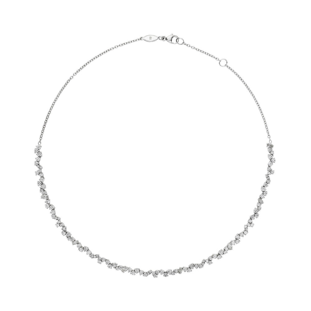 This 18k white gold necklace from the Stardust collection by Penny Preville features a scattered line of marquise, pear, and round diamonds set halfway around the necklace that total 3.74ctw. The line of diamonds are finished with a white gold chain with adjustable jump ring.