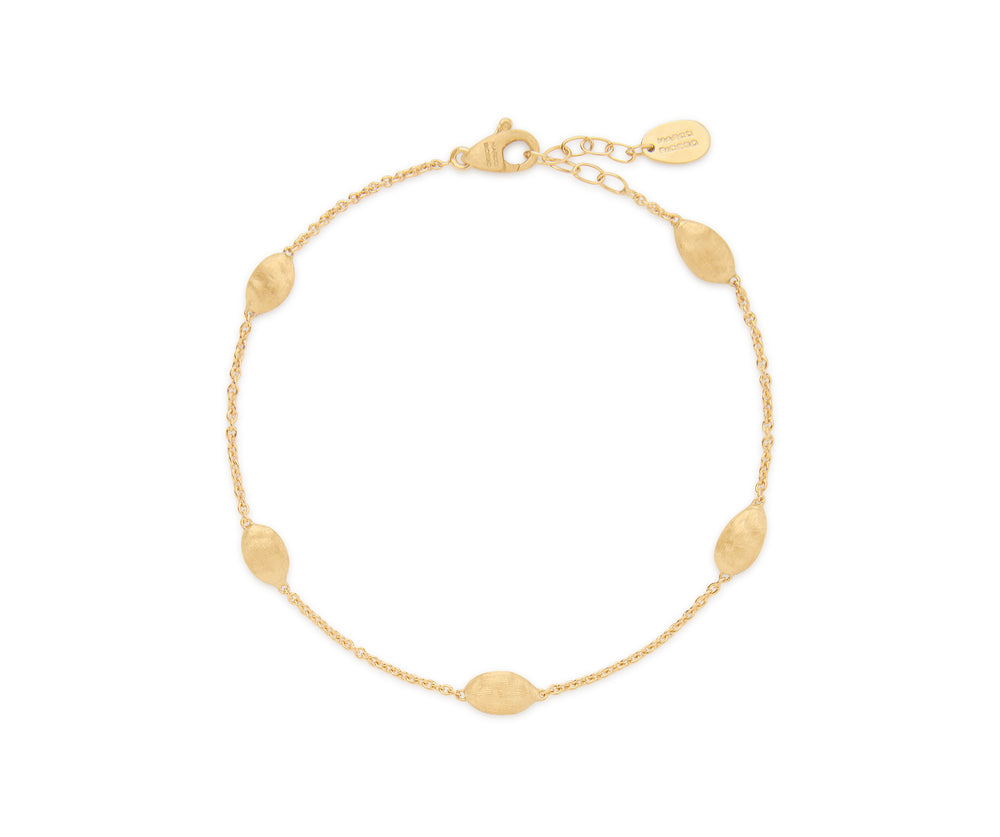 Yellow gold bracelet chain with five stations of hand engraved beads. Lobster clasp with chain extender. On a white background.