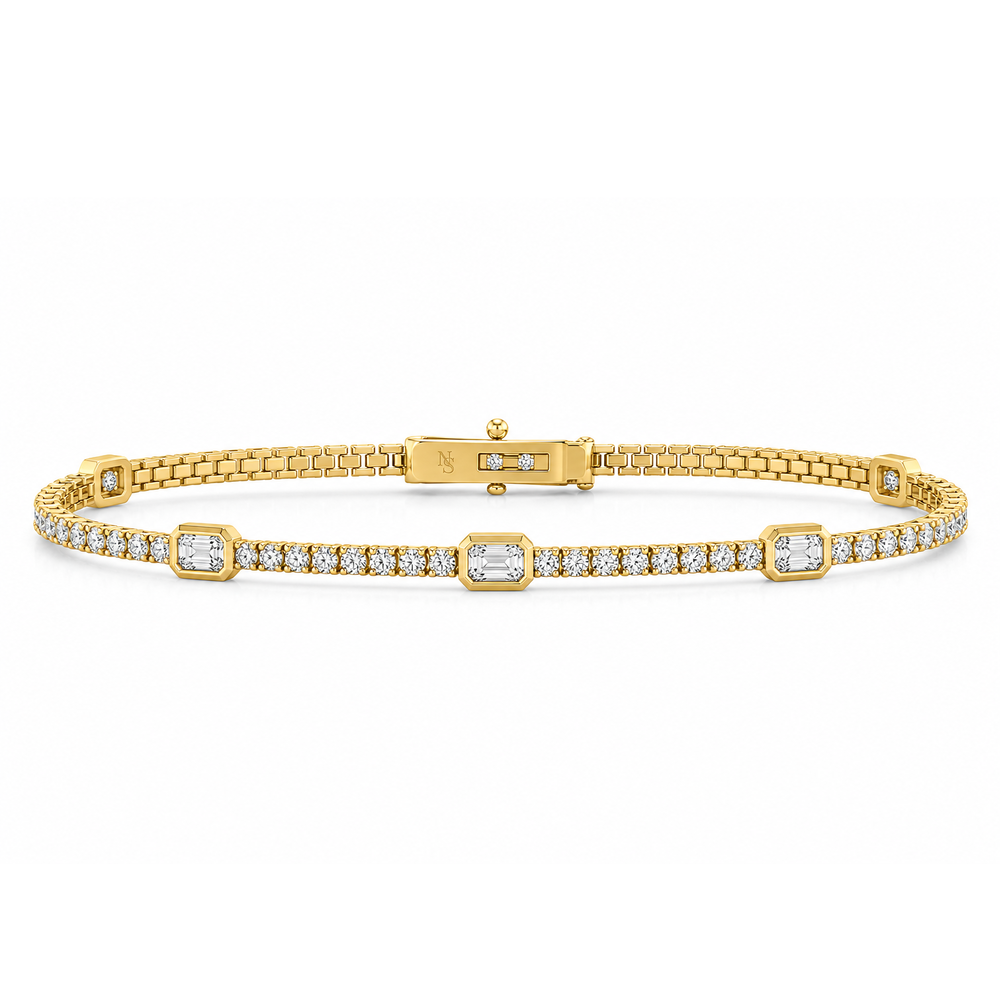 Diamond line bracelet with emerald and round diamonds.